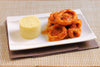 Squid pieces in spicy american sauce being served
