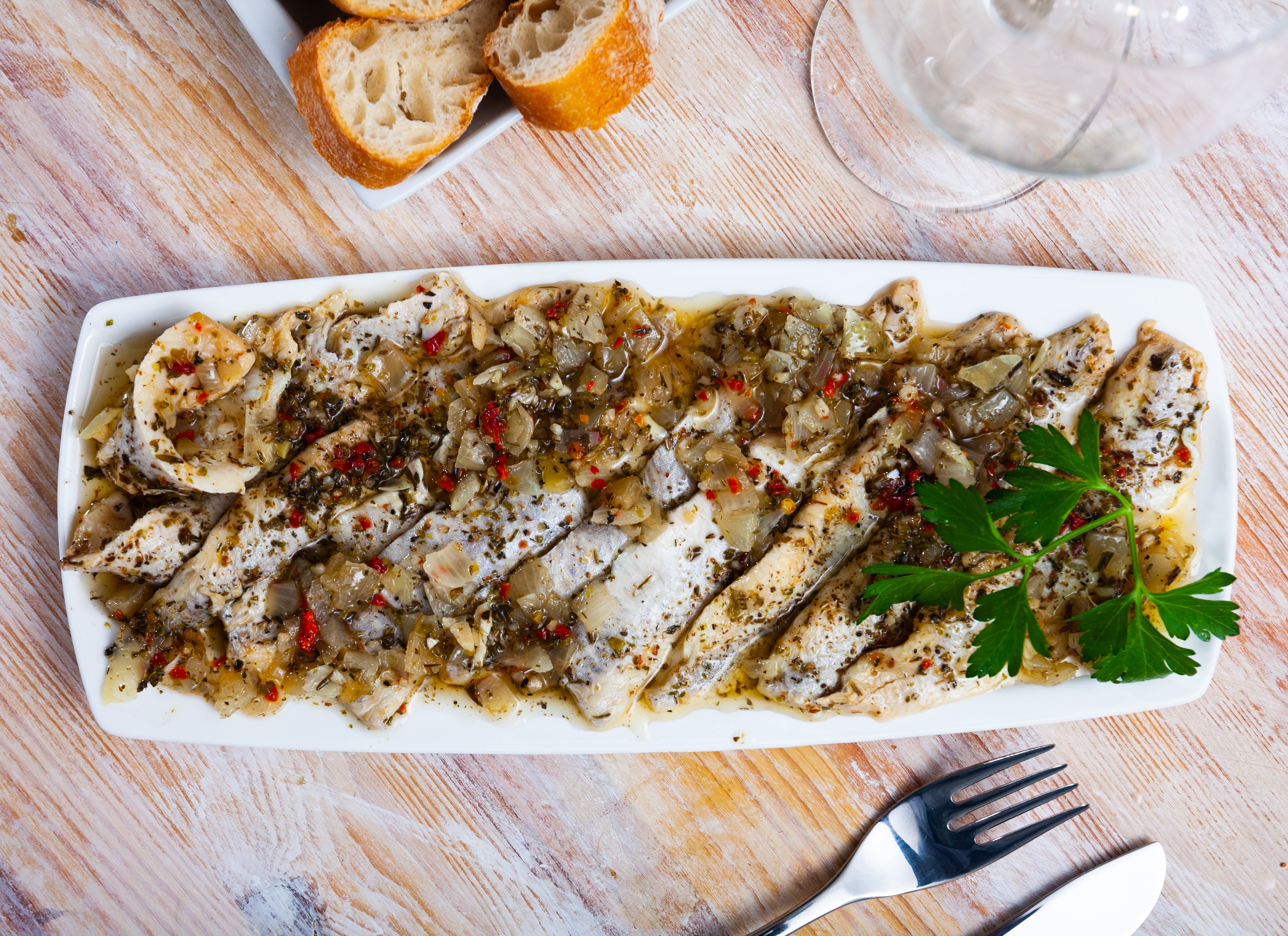 garfish in olive oil served on a plate